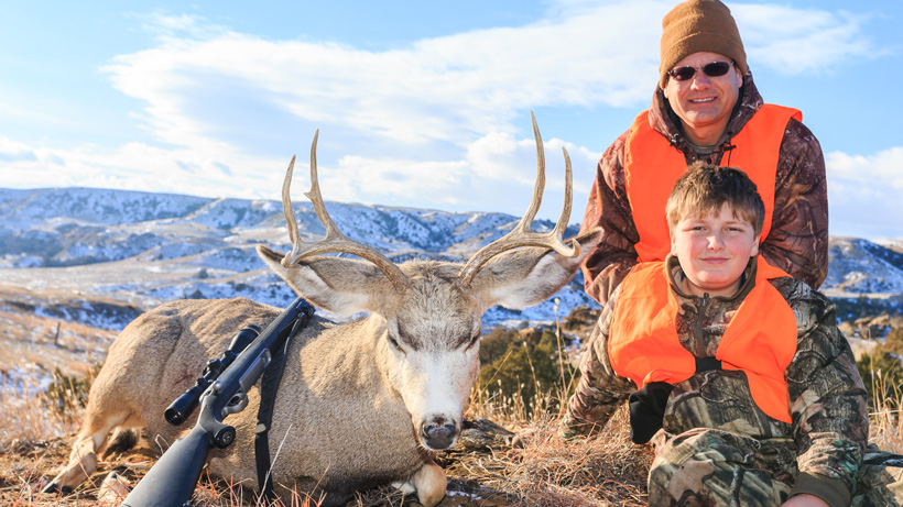 Youth hunter with his first mule deer buck Youth hunter with his first mule deer buck